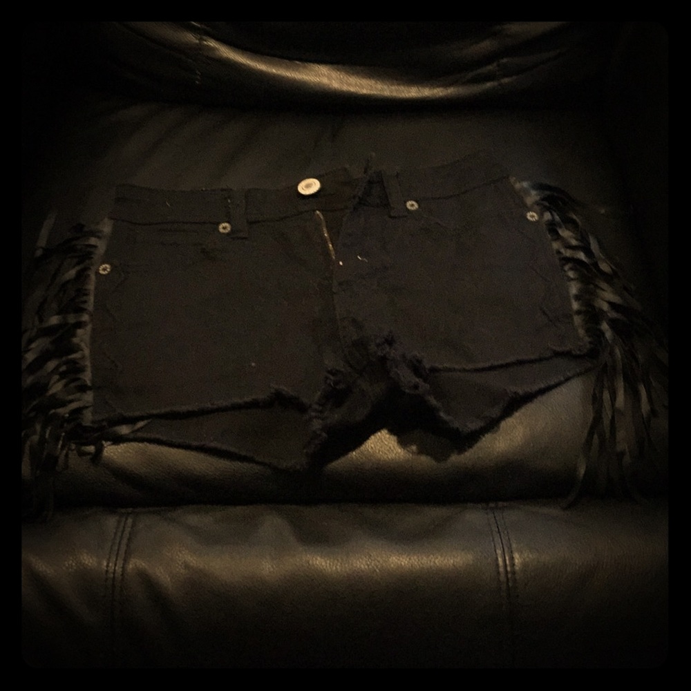 Black pair of shorts with blac leather strings